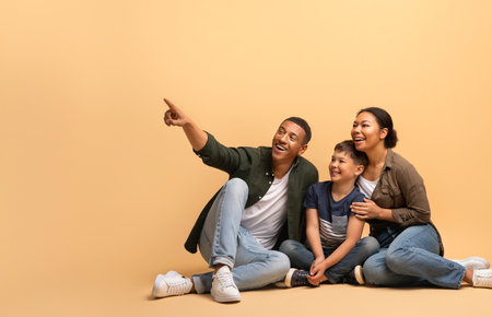 Family of three sharing joyful moments with love and laughter at homeの写真素材