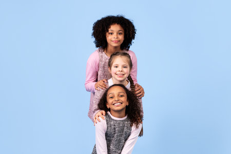 Three joyful girls celebrating friendship and diversity in a playful setting