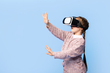 Happy girl exploring virtual reality while wearing a headset indoors