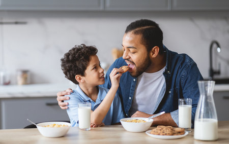 Family enjoys cookies and milk together in a cozy kitchen settingの写真素材