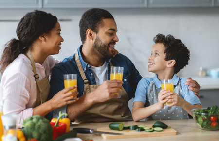Family together in the kitchen enjoying fresh juice and quality timeの写真素材