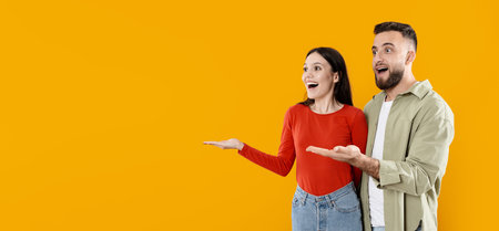 Excited couple celebrating a special moment against a vibrant backdropの写真素材