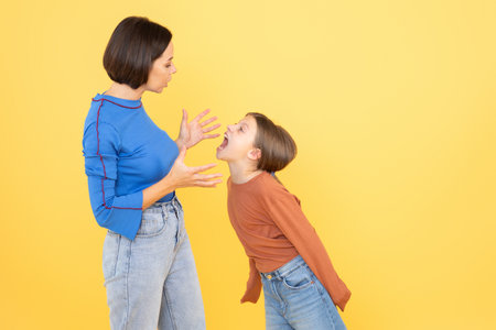Mother and daughter sharing a lively moment of communication and expressionの写真素材
