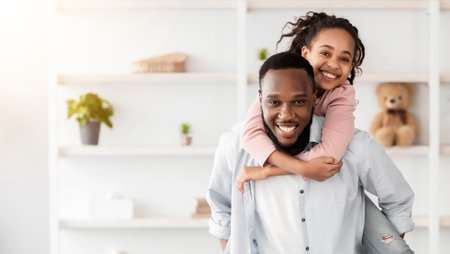 Portrait of black dad and daughter spending time at homeの写真素材