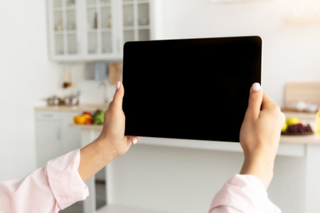 Woman using digital tablet with blank empty screen, mockupの写真素材
