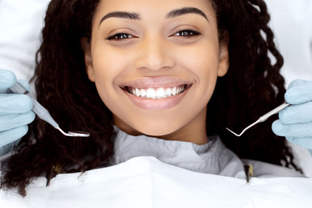 Portrait Of Happy Young Black Woman Having Check Up At Dental Clinicの写真素材
