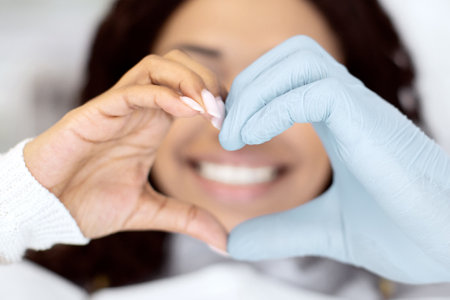 Closeup Of Dentist Doctor And Female Patient Making Heart Gesture With Handsの写真素材