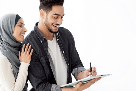 Real estate agent giving middle-eastern family key from apartment