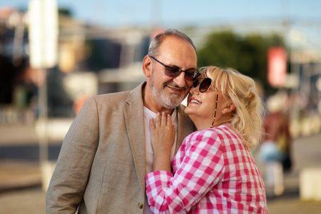 Happy couple enjoying a joyful moment together outdoors in the cityの写真素材