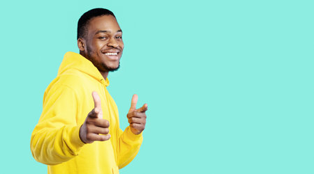 African American Man Pointing Fingers At Camera On Blue Background