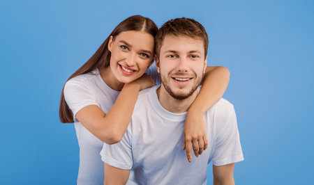 Portrait of beautiful young couple smiling at studio