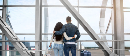 Traveling Together. Rear View Of Young Couple Standing At Airport Terminalの写真素材
