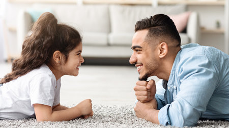 Cute arab father and little kid having fun at homeの写真素材