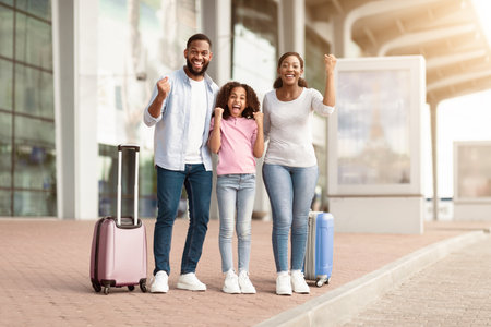 Happy black family traveling with kid, screaming yesの写真素材
