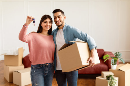 Happy couple showing keys of their apartment