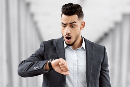 Late To Flight. Worried Man Checking Time On Wristwatch At Airport