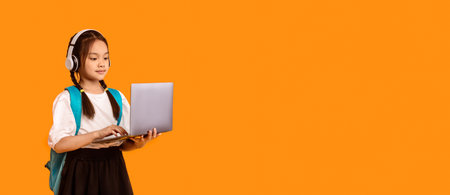 Asian School Kid Girl With Laptop Learning Standing In Studioの写真素材