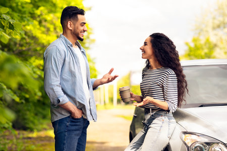 Happy couple having break while travelling by car togetherの写真素材