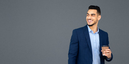 Handsome arab guy businessman with coffee on the streetの写真素材