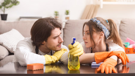 Tired Of Cleaning. Couple Leaning On Table Exhausted After Tidying Up Apartment