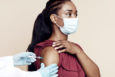 Side view of black woman getting vaccinationの写真素材