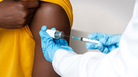 Doctor In Blue Gloves Taking Dose Of Vaccine From Vial With Syringe
