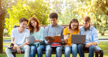 Multiracial students studying together in the park