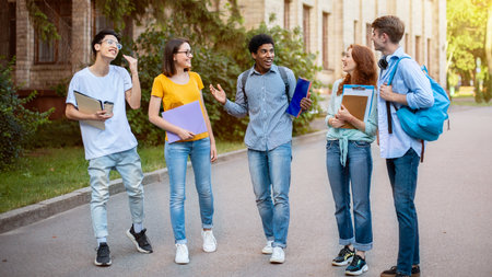 Multiethnic Freshmen Students Talking Walking In University Campus Outsideの写真素材