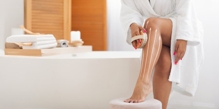 Woman pampering herself with body sculpting techniques in a serene spa settingの写真素材