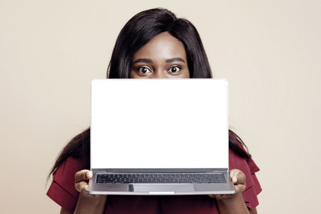 Young black lady holding notebook with empty screen, mockupの写真素材
