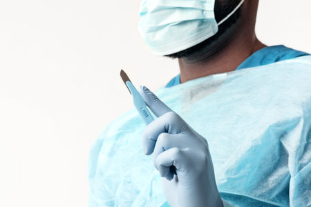 Doctor in scrubs preparing for surgery in a clean hospital environmentの写真素材