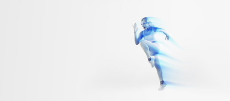 Fit woman running and screaming at blue studio backgroundの写真素材