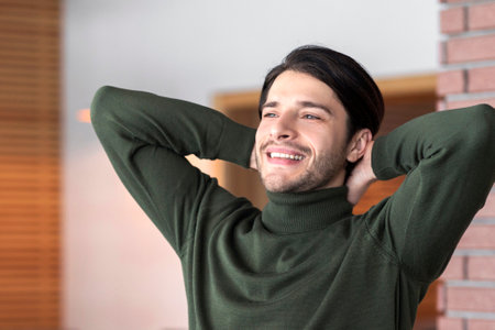 Joyful male sitting in front of laptopの写真素材