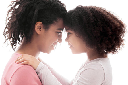 Portrait Of Loving African American Mom And Daughter Bonding Togetherの写真素材
