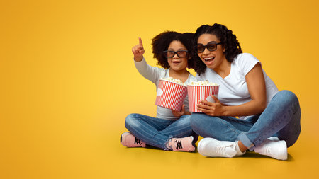 Cheerful African Mom And Daughter In 3d Glasses With Popcorn Bucketsの写真素材