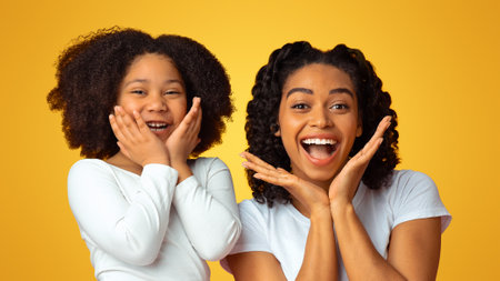 Overjoyed Black Mom And Her Little Daughter Touching Cheeks In Excitementの写真素材