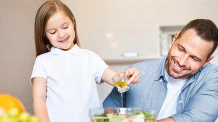 Smiling Father And Daughter Making Salad Cooking In Kitchen Indoorsの写真素材
