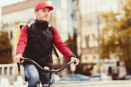 Delivery Guy Posing With Bike In Urban Area Outdoorsの写真素材
