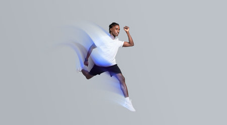 Dynamic man in sportswear running on grey studio background