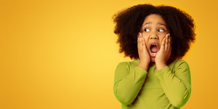 Portrait Of Shocked Little Girl Touching Her Face In Amazementの写真素材