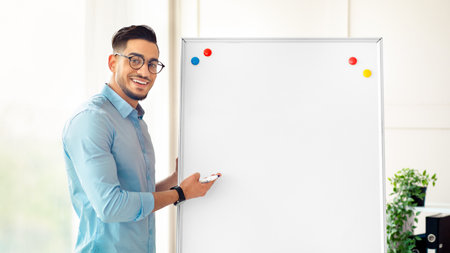 Young Arab businessman presenting in a corporate office settingの写真素材