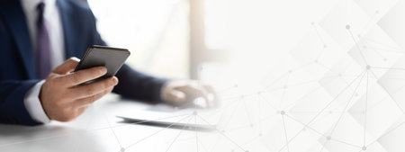 Unrecognizable Man Entrepreneur Using Smartphone And Working With Laptop In Office