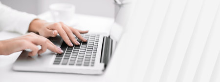 Cropped image of latin lady working on laptopの写真素材