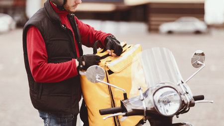 Unrecognizable Courier Opening Delivery Backpack With Food Outdoors, Cropped, Panoramaの写真素材