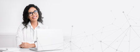 Smiling latin businesswoman working at modern officeの写真素材