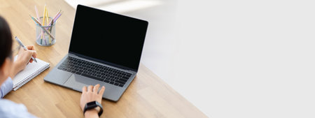 High angle view woman using laptop with blank screenの写真素材
