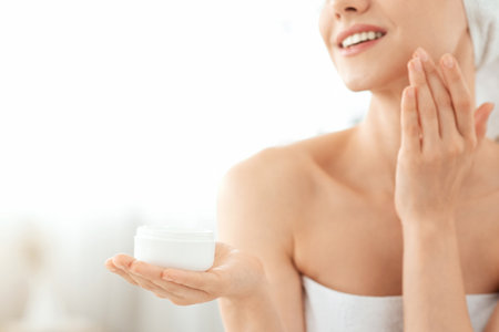 Jar with cream in young woman handsの写真素材