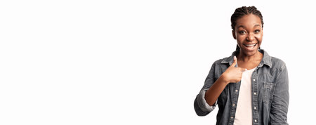 Happy young woman smiling and giving a thumbs up in a bright settingの写真素材