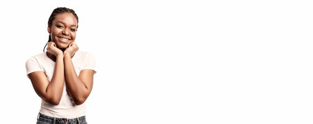 Young woman smiling with hands on face in bright studio settingの写真素材