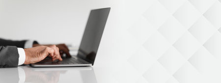 Close-up of a businessmans hands typing on a laptop keyboardの写真素材